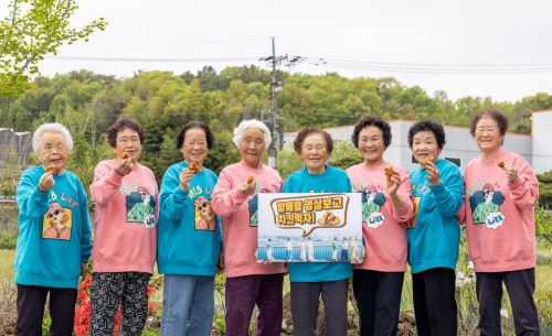 할매들 영상 보고 치킨 먹자 수니와 칠공주가 통영 바다를 배경으로 촬영된 해양관광 캠페인 영상의 댓글 이벤트를 알리며 밝게 웃고 있다사진칠곡군 제공